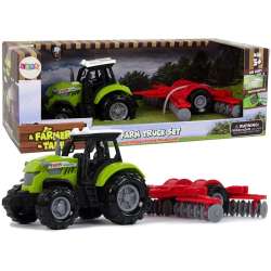 Traktor ze zgrabiarką zielony