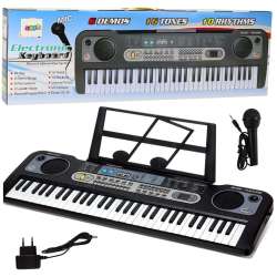 Keyboard z mikrofonem, stojakiem i nutami